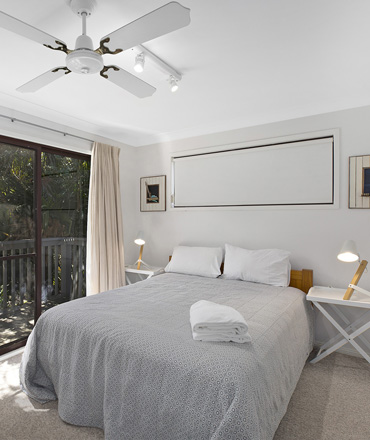 This bedroom for Copacabana accommodation has a private balcony as well as queen be.