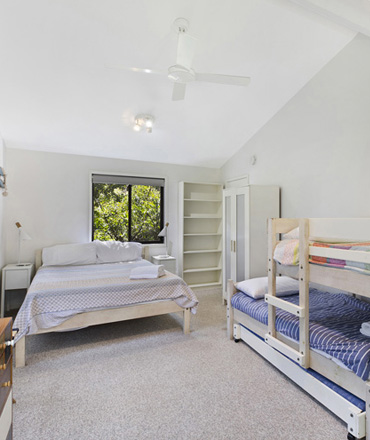 Copacabana accommodation features this family room with queen bed, 2 bunk beds for the children and a private balcony.